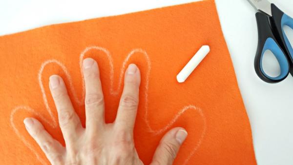 Trace around your hand with chalk to outline the finger play glove