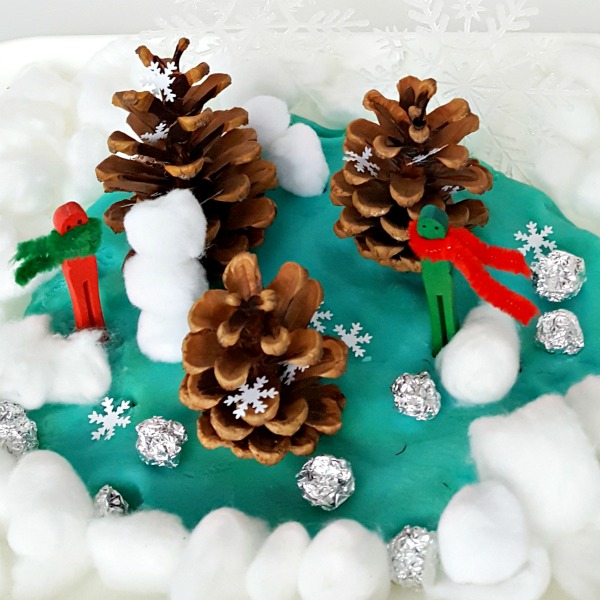 Kids small world forest winter craft and activity with pine cones